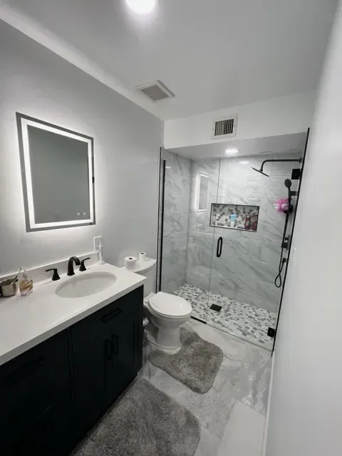 Modern bathroom fixtures including floating vanity and freestanding tub