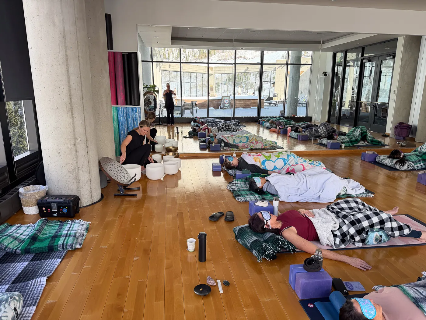 Participants relaxing on mats in a spacious wellness studio