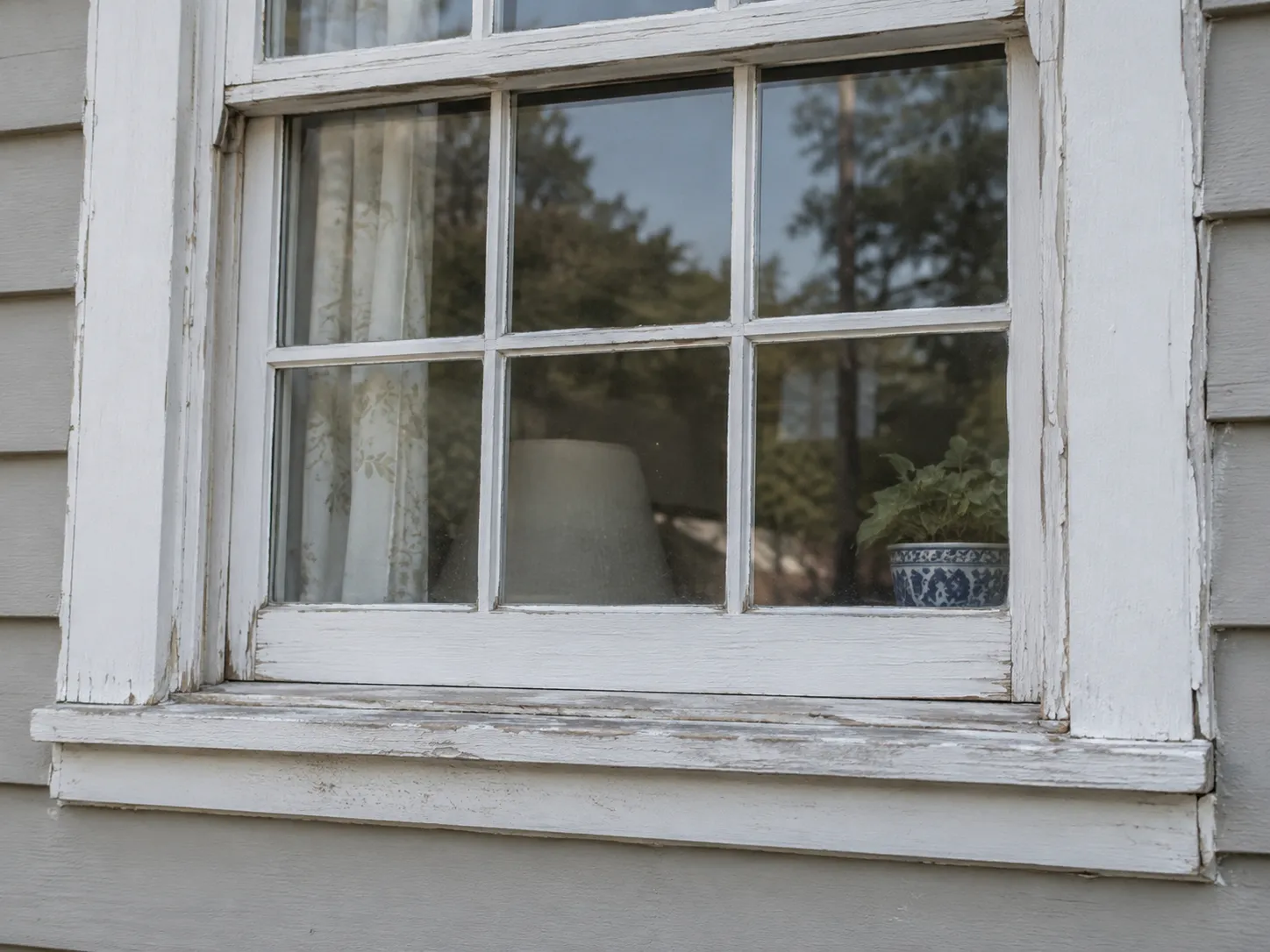 Older window frame showing wear from coastal weather exposure