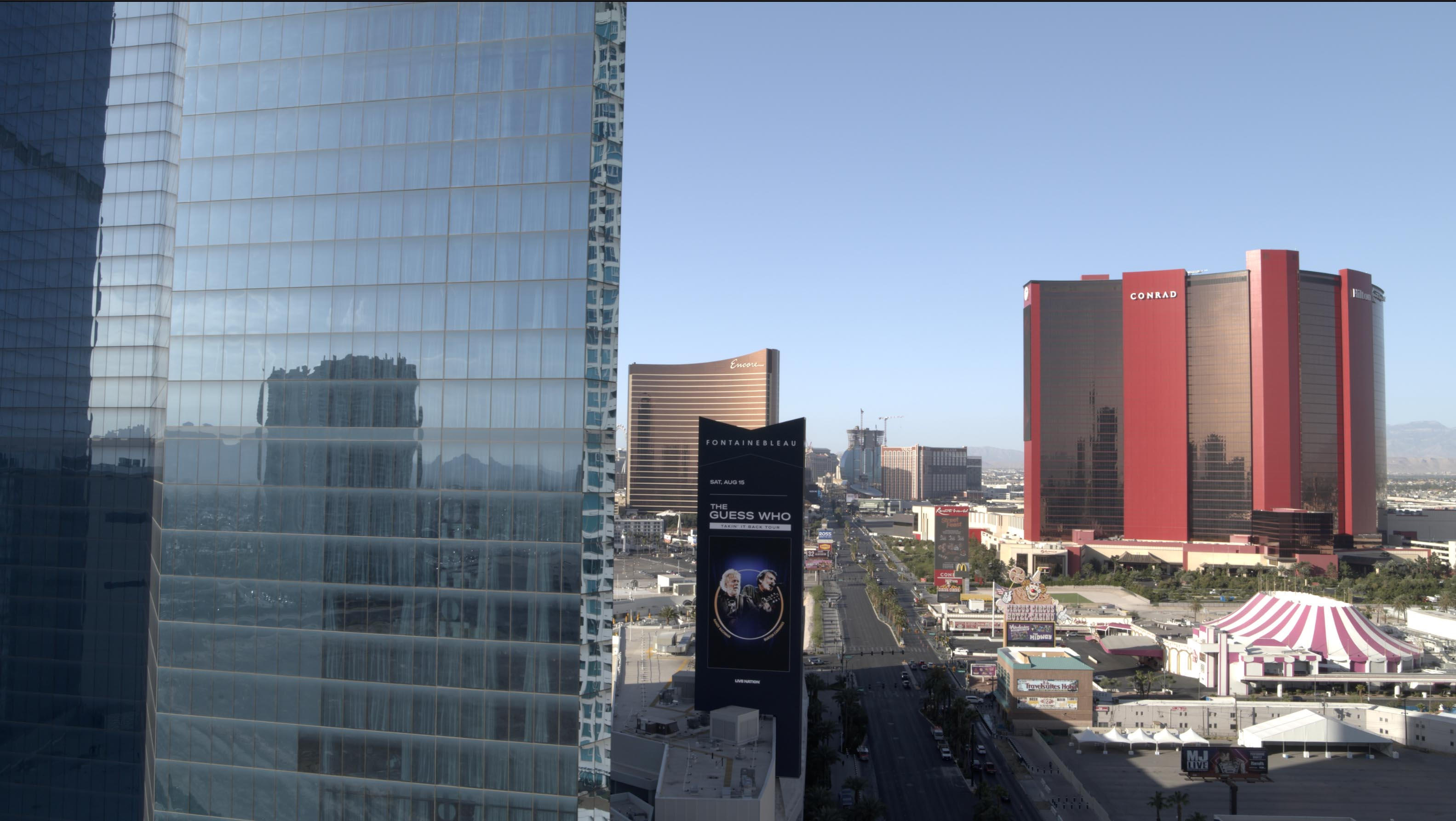 Skyline view featuring modern buildings and a large digital billboard