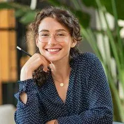 Life coach and client discussing goal-setting strategies in a professional office environment