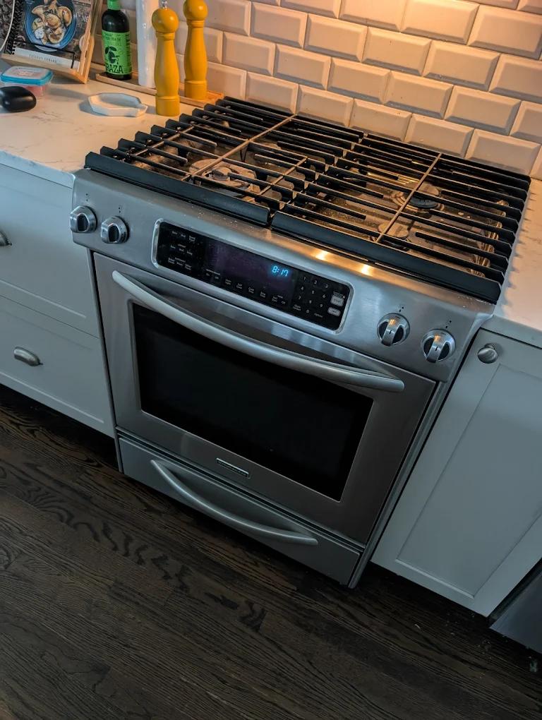 Clean and organized commercial kitchen with fully operational appliances, illustrating the benefits of regular maintenance services
