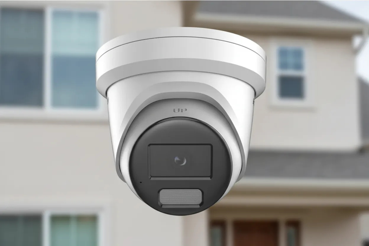 Wireless security camera installed on a house monitoring the front yard