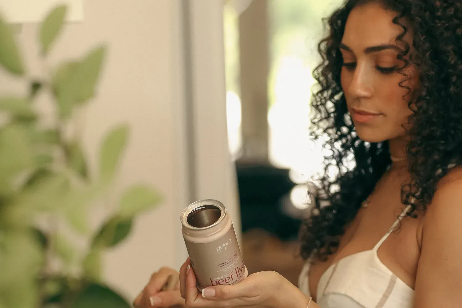 Woman applying skincare product highlighting collagen benefits for skin health