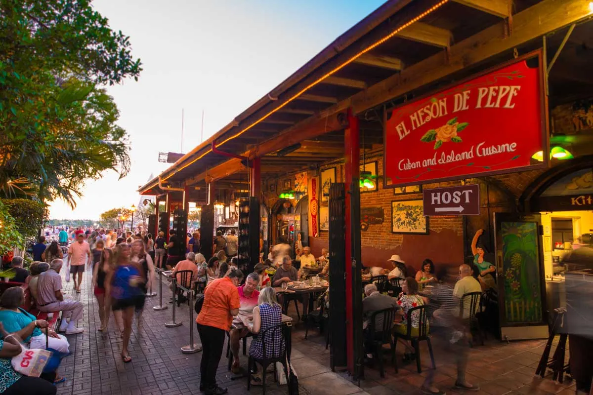 Diners enjoying Cuban cuisine with live music at El Mesón de Pepe