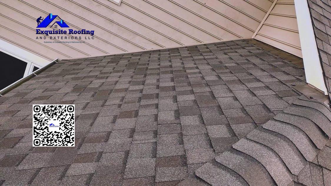 ### Key Elements - **Main Subject**: Roof shingles - **Notable Features**: Textured shingles, sloped roof