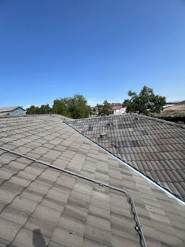 Residential rooftops under clear blue sky in Southern California, metal roof durability