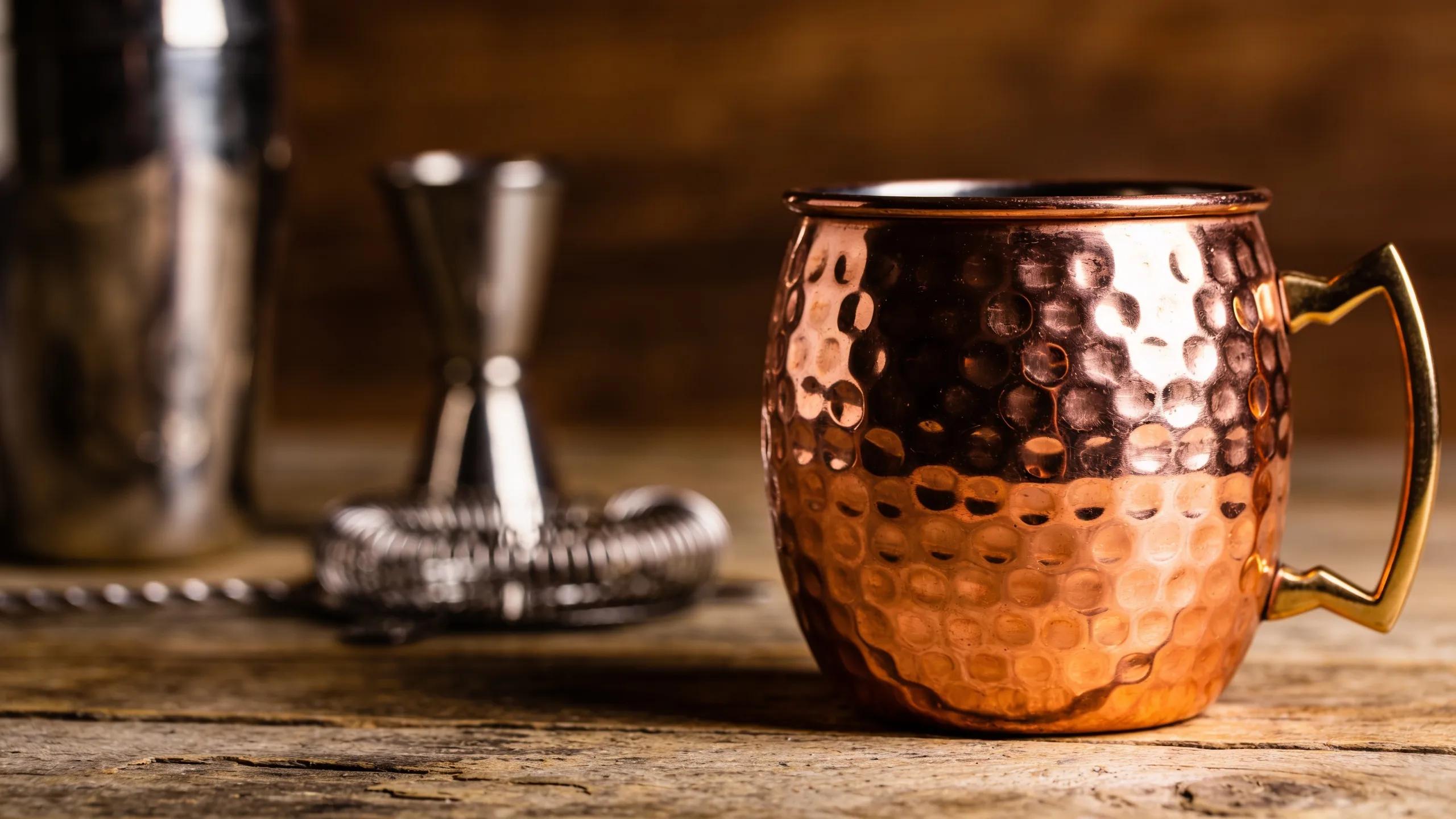 Close-up of a hand-hammered authentic copper mug, emphasizing craftsmanship and quality in cocktail preparation