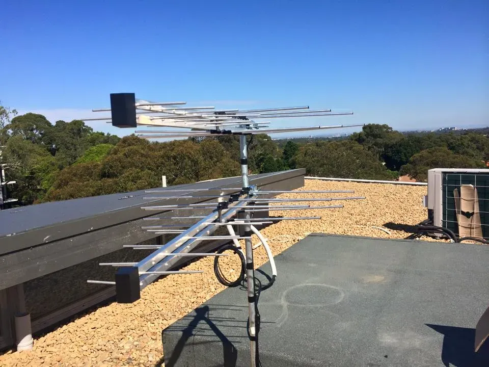 Antenna installation in Blacktown showcasing diverse antennas on roofs amid a suburban landscape