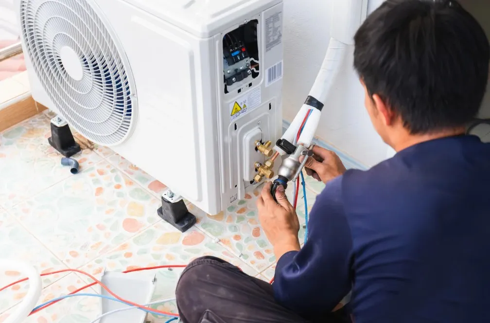 Technician diagnosing a common AC problem in a Sussex County home