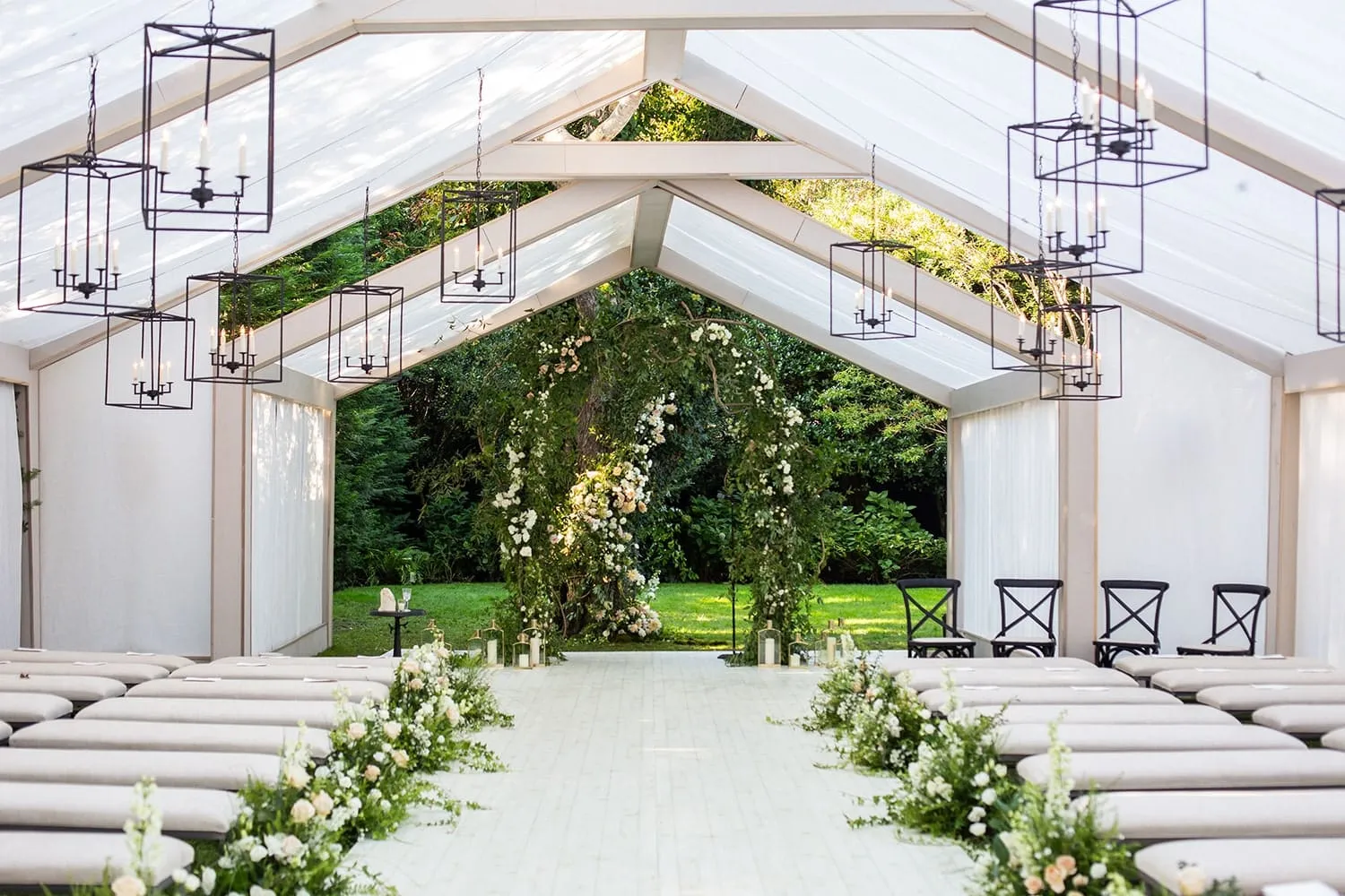 Clear sidewalls allowing scenic autumn views during an outdoor wedding