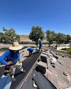 Roofing contractor installing metal panels on a Southern California residential home