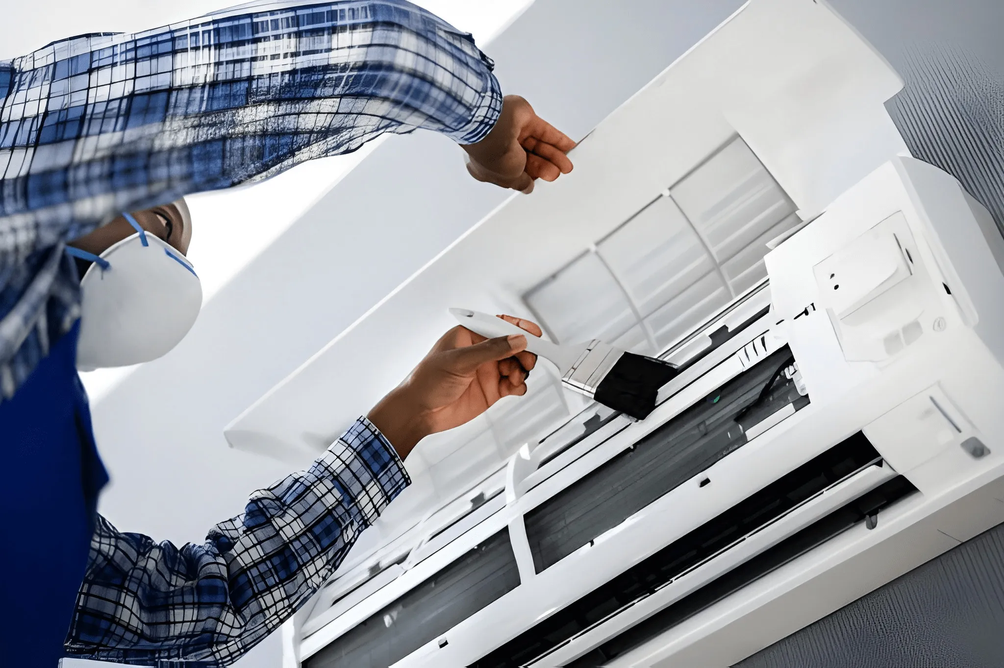 Technician inspecting a commercial AC unit for signs requiring urgent repair.