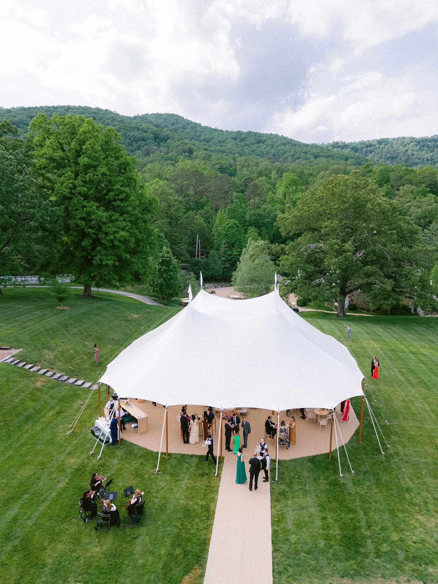 Welcoming fall wedding lounge with comfortable furniture, warm lighting, and seasonal decorations