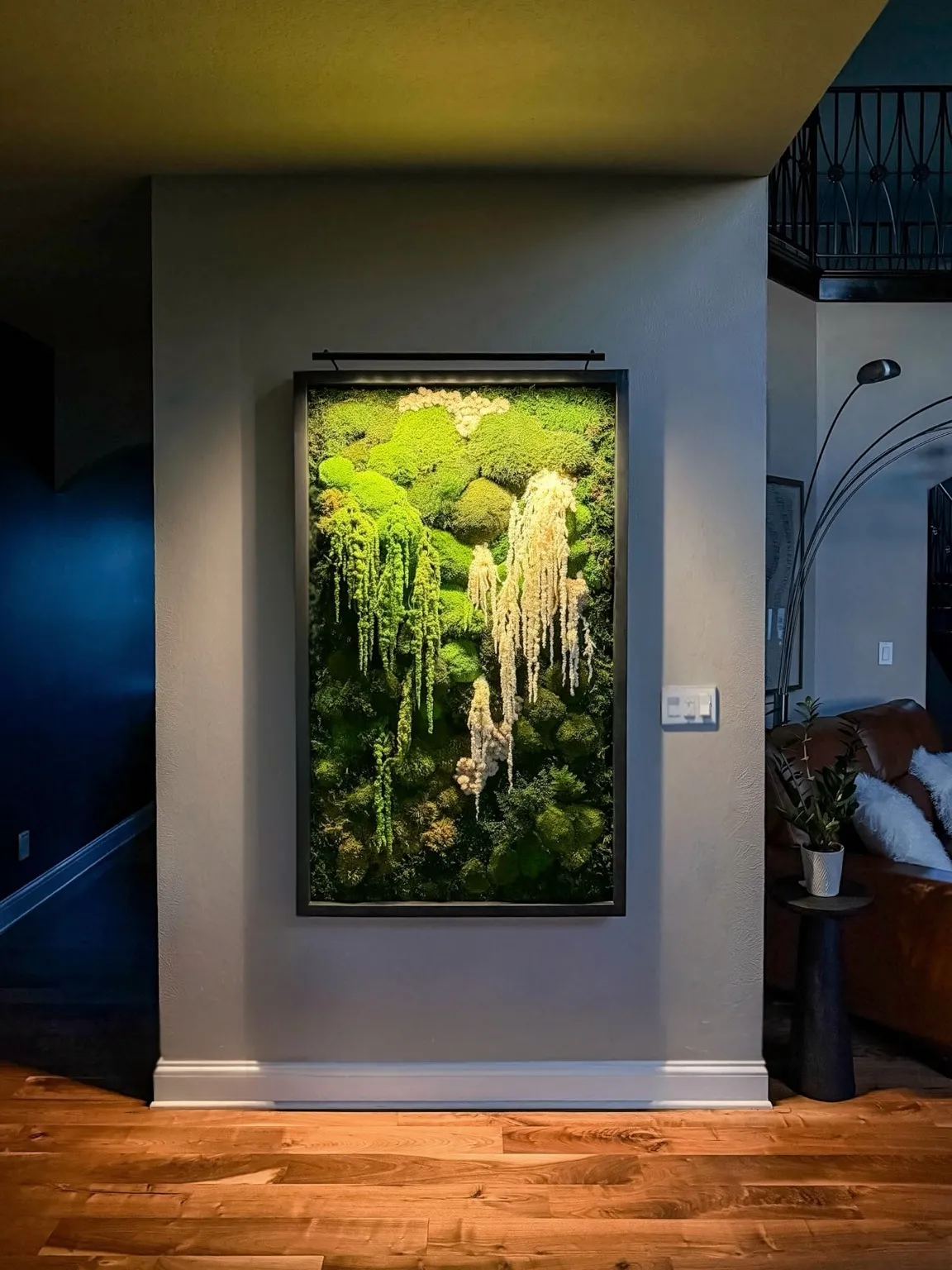 Professional installation of plants focusing on a living wall, showcasing meticulous arrangement and tools used