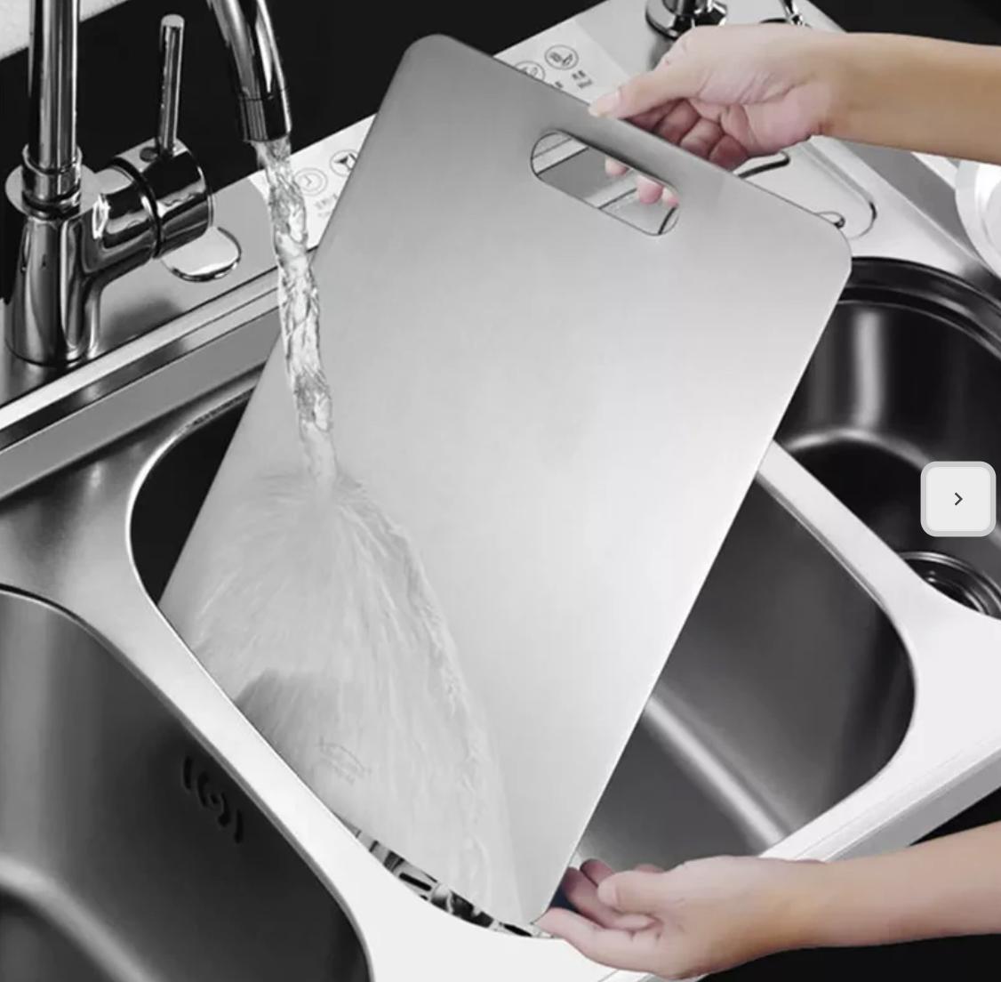 Chef chopping vegetables on a durable titanium cutting board in a professional kitchen