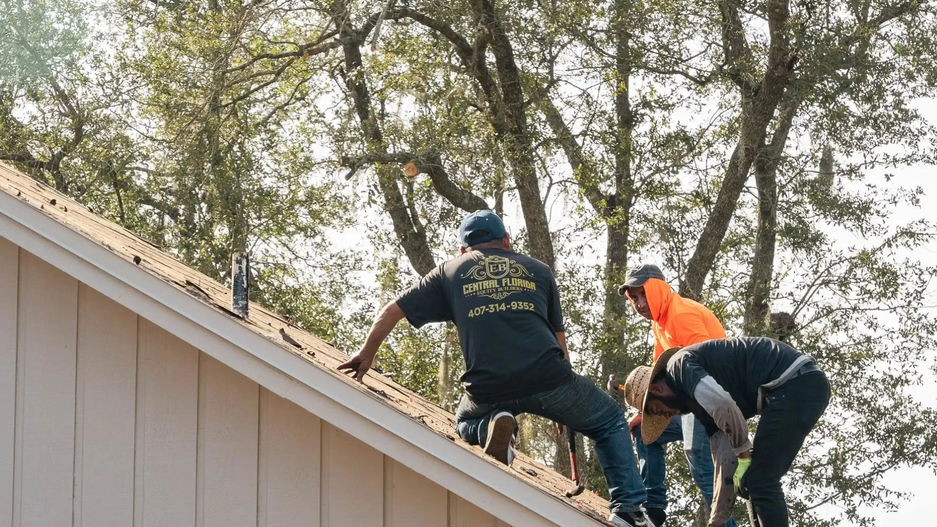 Roofing contractor performing a wind mitigation inspection on a Florida home