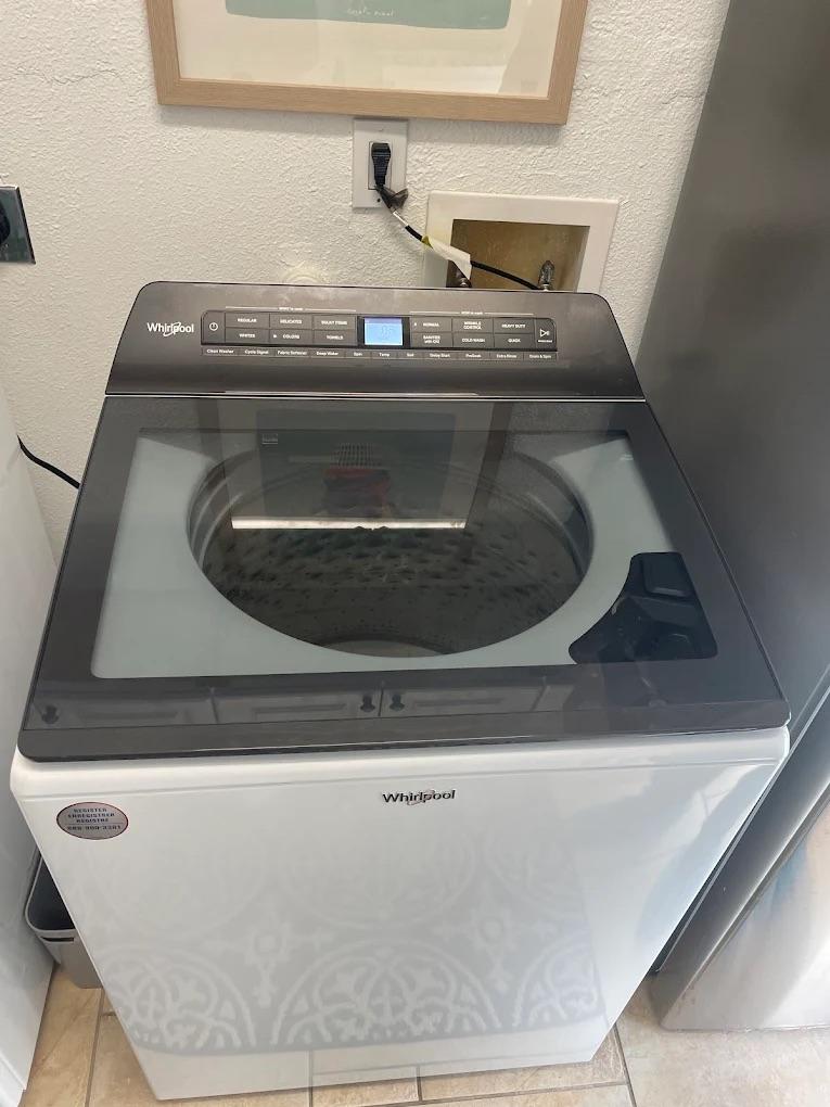 ### Main Subject - Whirlpool Washing Machine ### Notable Features - Top-loading design - Digital