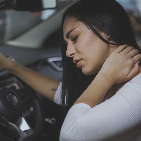 Chiropractor assisting a patient in recovery after a car accident in a modern clinic
