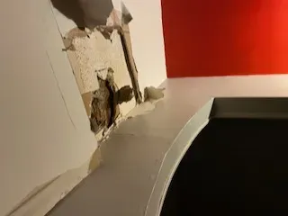 Handwritten questions about hiring a public insurance adjuster on a notepad