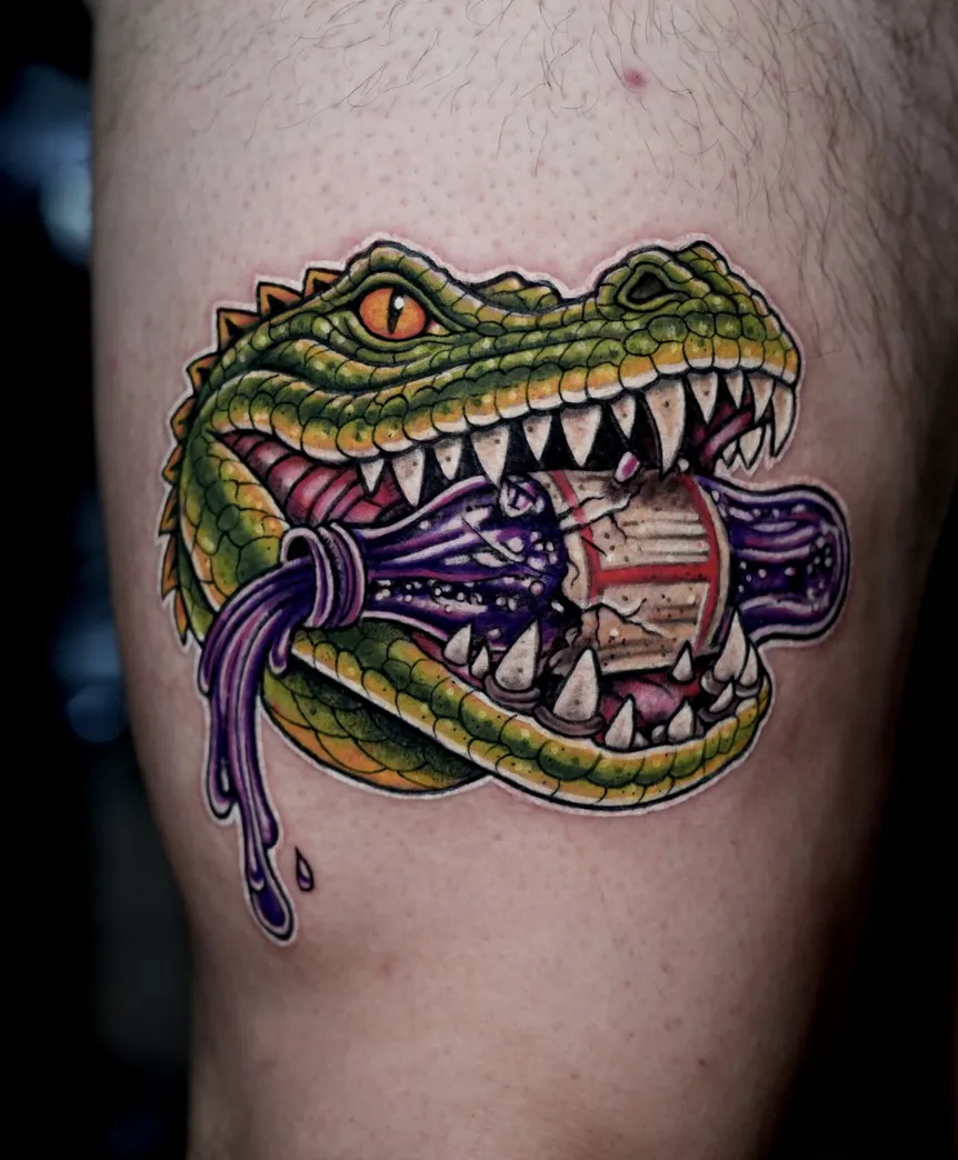Vibrant neo-traditional alligator tattoo biting a purple liquid bottle, with bold black outlines and bright color saturation.