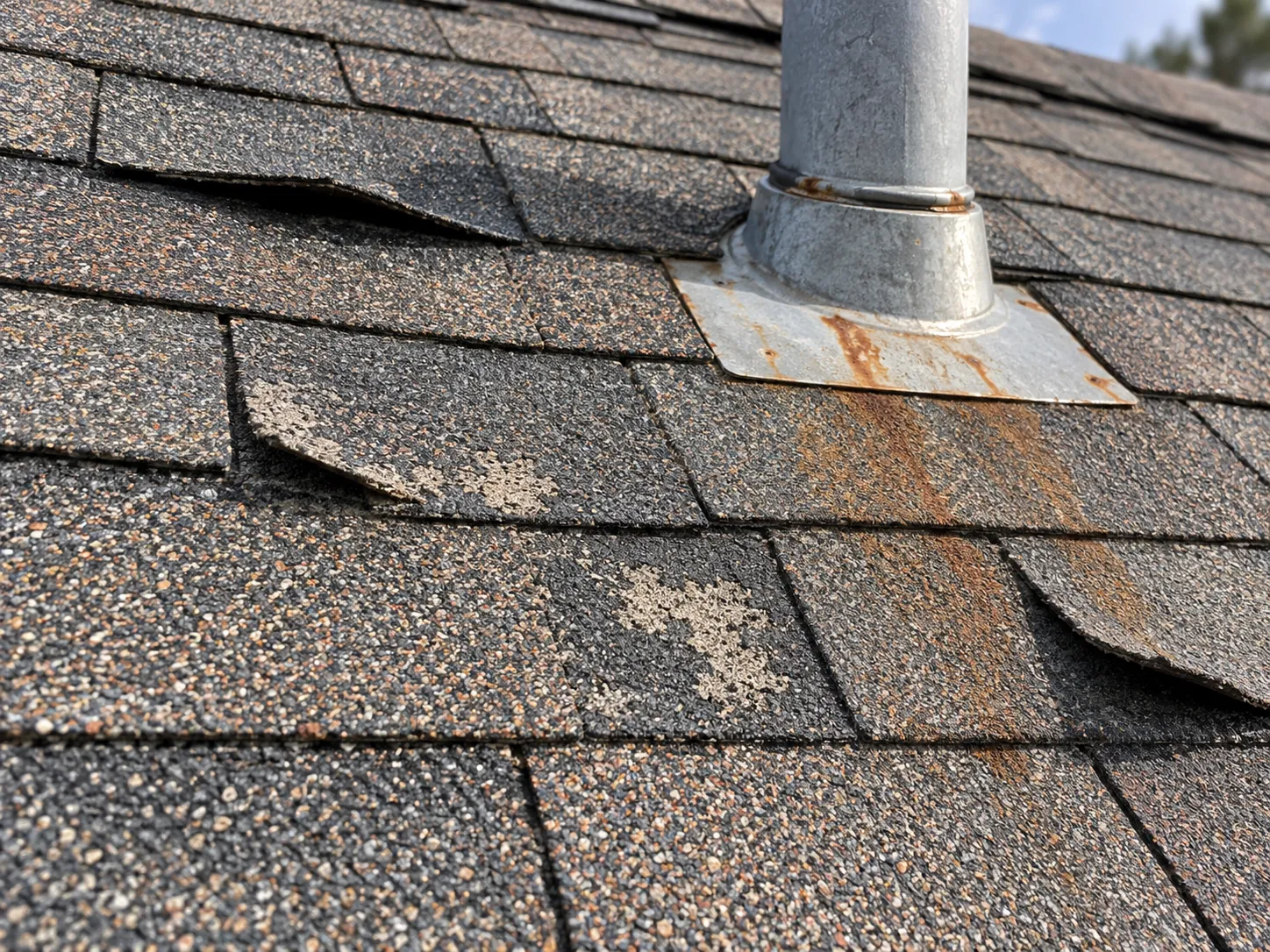 ifted shingles and rusted flashing