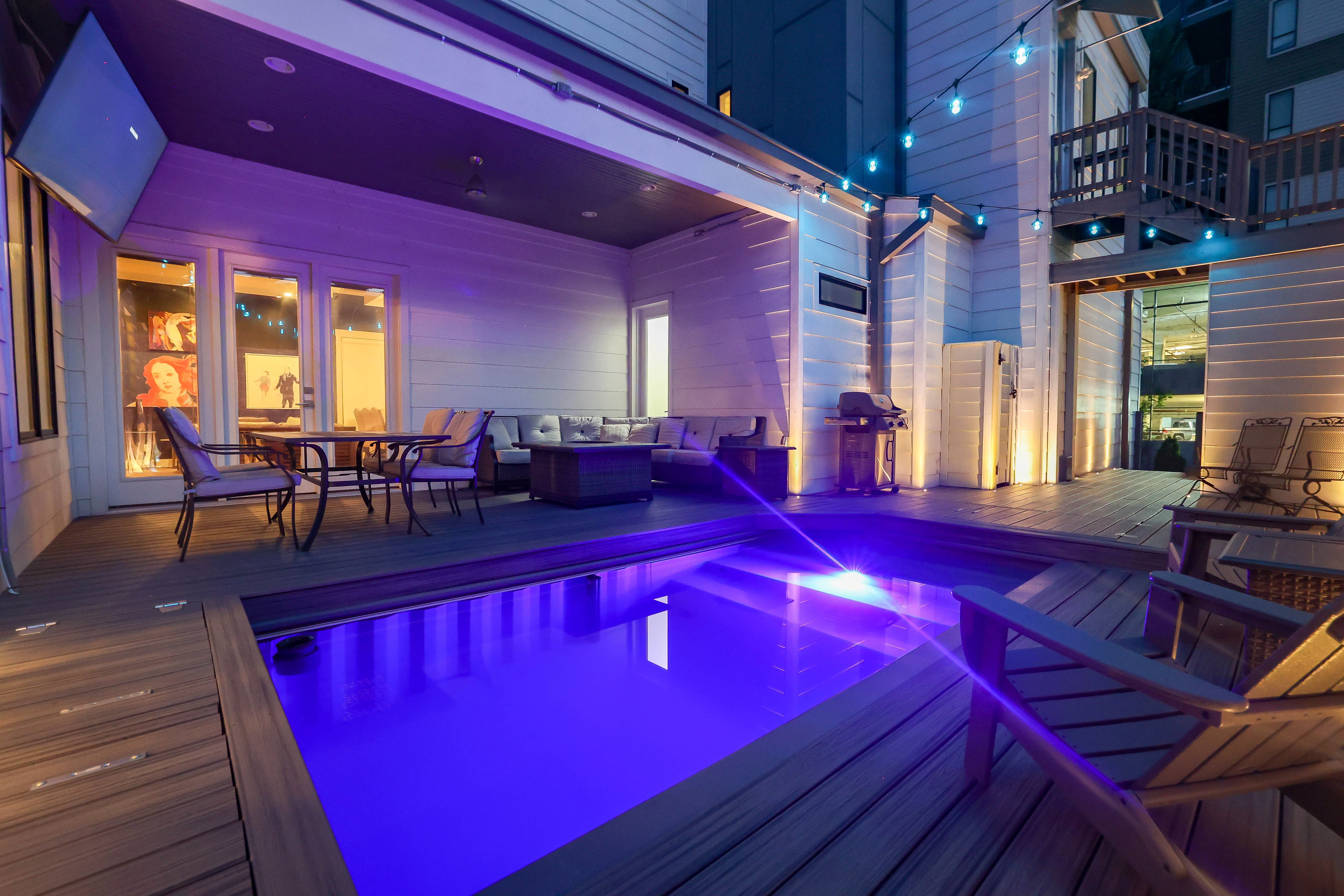 Book 615 outdoor pool deck with ambient lighting — luxury short-term rental Nashville, The Gulch