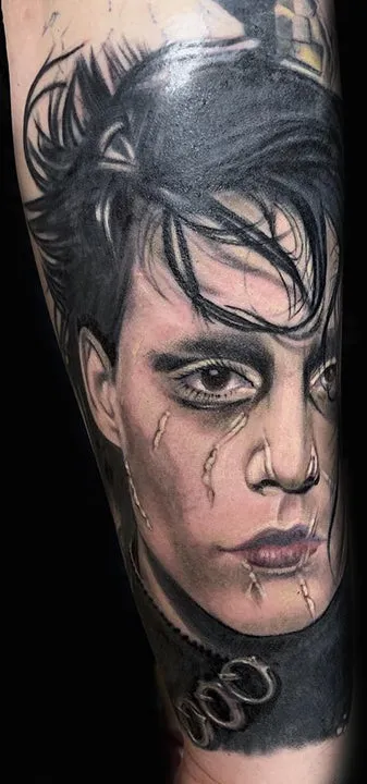 Detailed black and grey portrait tattoo of Edward Scissorhands featuring realistic facial scars and messy hair.
