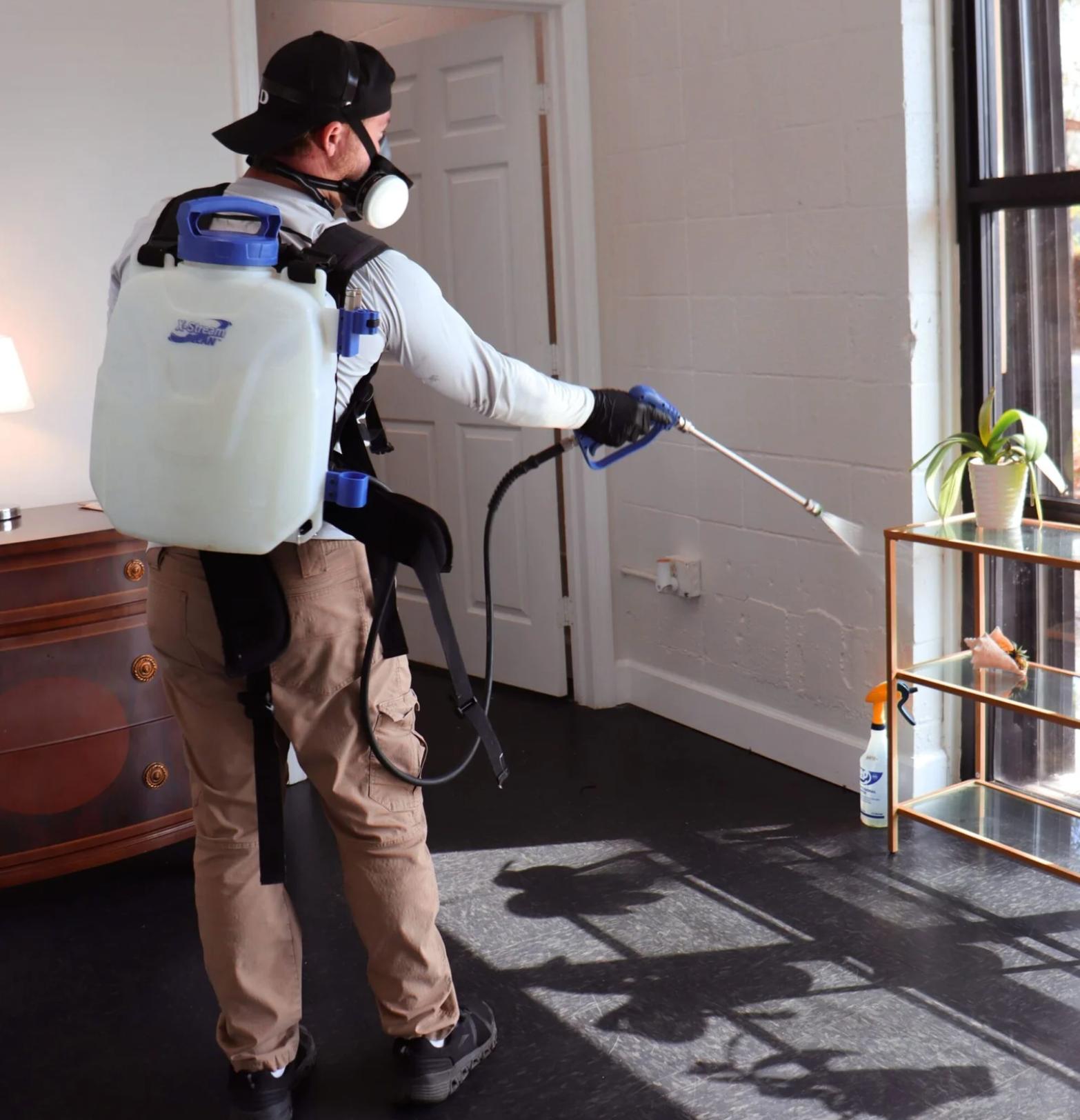 Pest control professional applying eco-friendly products with safety gear