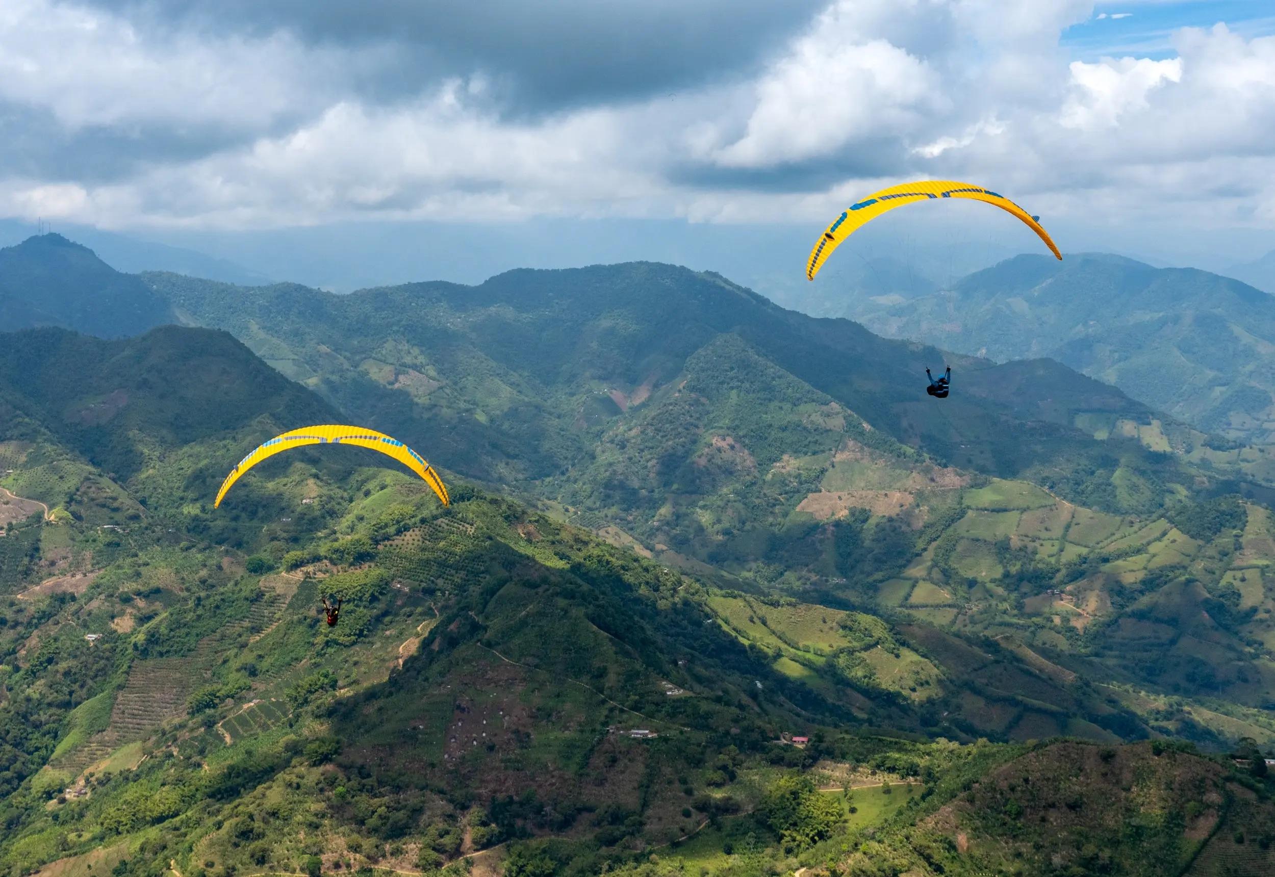 Group of pilots preparing Ozone Vibe GT paraglider for flight, showcasing skill diversity and Australian conditions