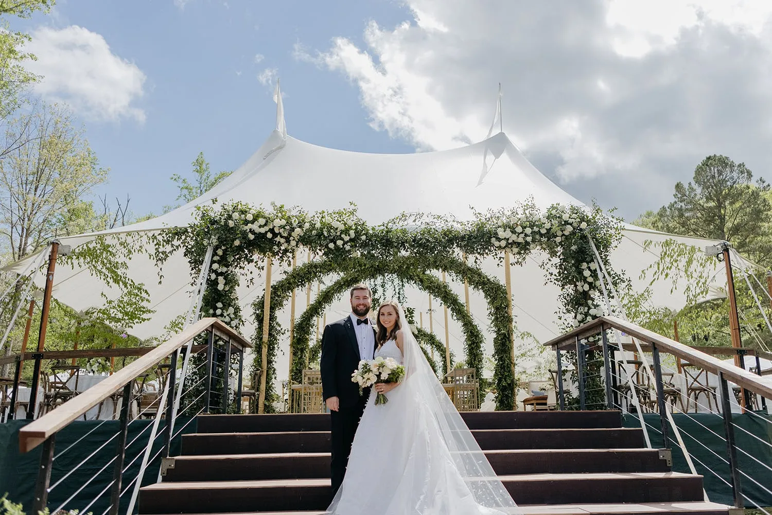 Couple consulting about site logistics for fall wedding tent installation Couple consulting about site logistics for fall wedding tent installation