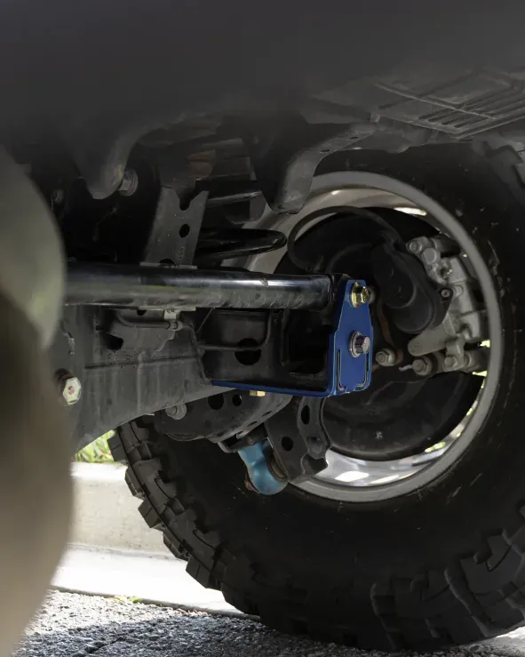 Close-up of upgraded sway bar links installation on Lexus GX460 demonstrating precision in vehicle upgrades
