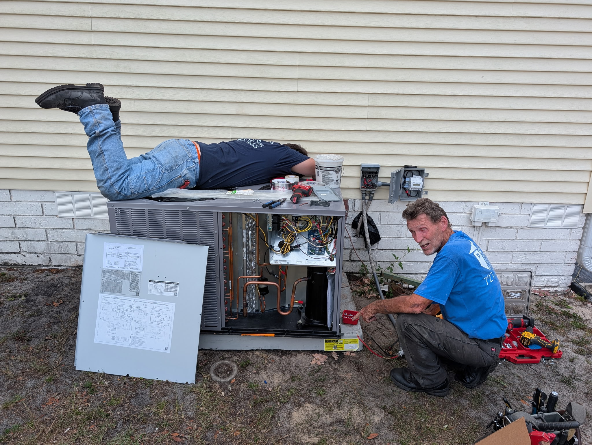 HVAC technician performing outdoor AC maintenance to improve system performance and help prevent unexpected breakdowns.