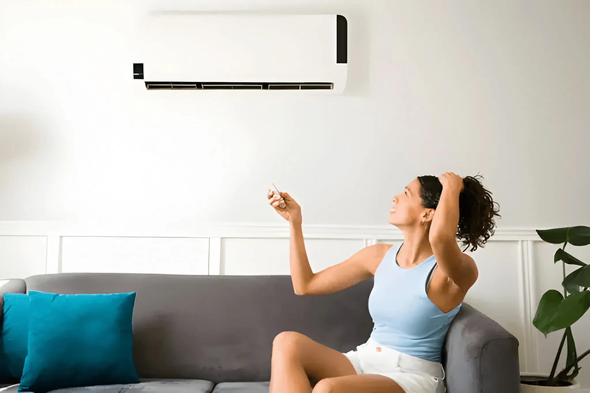 Homeowner adjusting an AC unit while experiencing potential cooling performance concerns