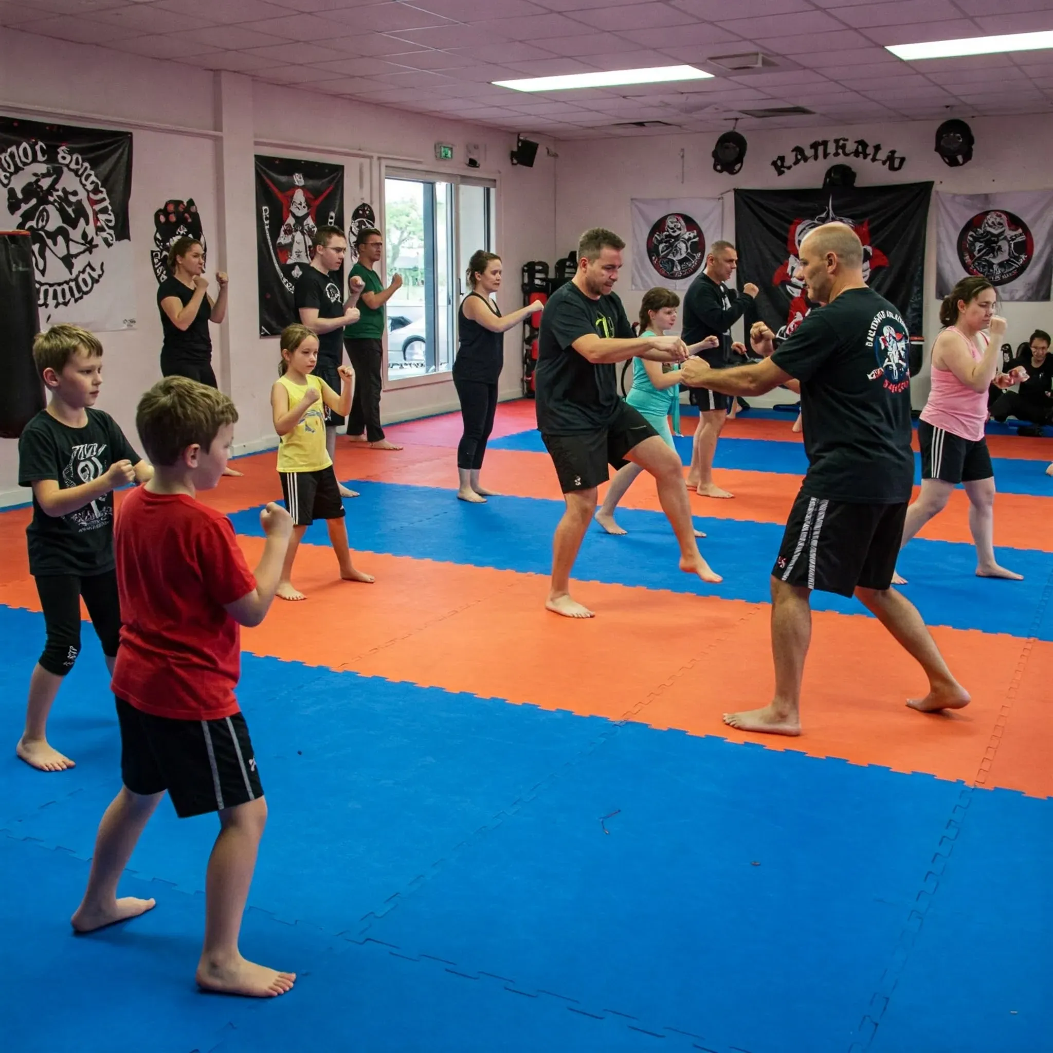 Adults practicing karate techniques in a professional dojo setting, emphasizing martial arts training