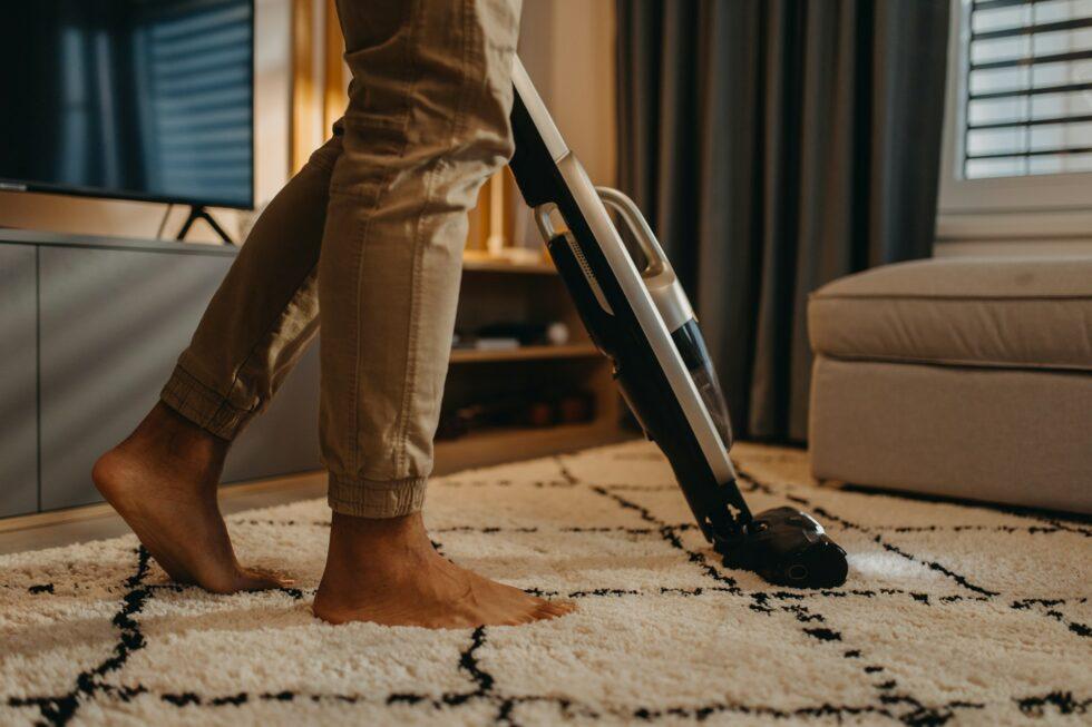Person using DIY methods to remove a coffee stain from a carpet, illustrating effective home cleaning techniques