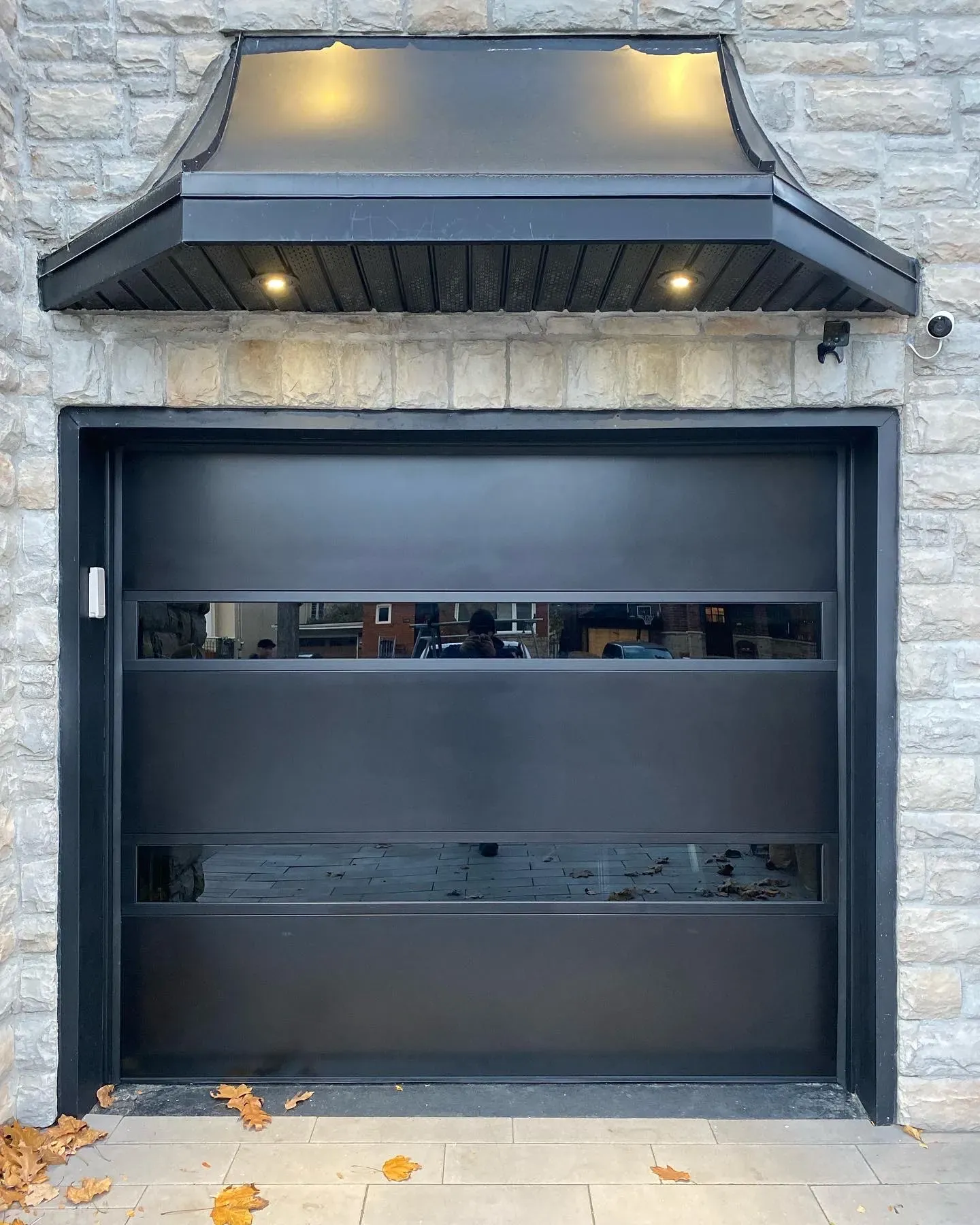 Garage door repair technician working in a garage