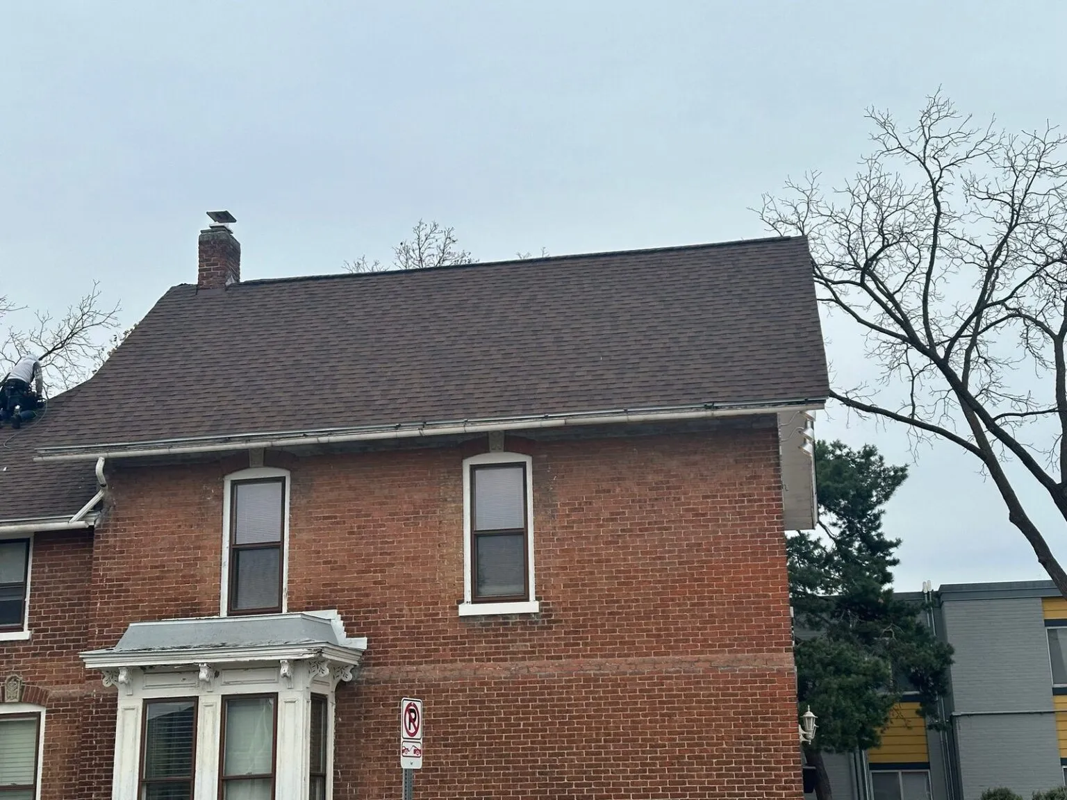 Professional inspecting a commercial roof for maintenance practices to preserve color longevity
