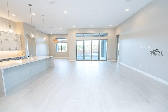 Family and friends socializing in an open floor plan kitchen