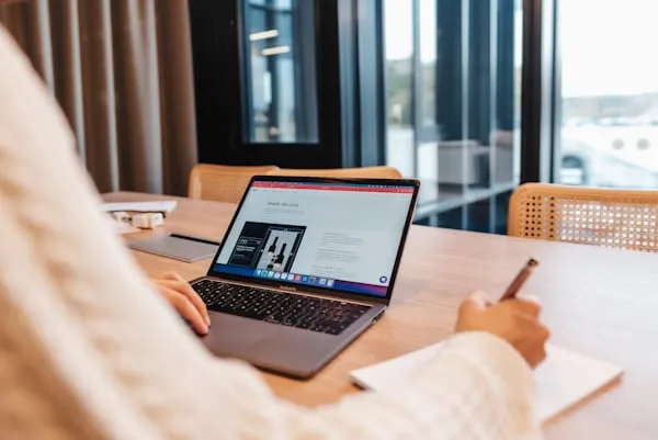 Business owner reviewing web design agency portfolio in a cozy café, emphasizing local evaluation methods