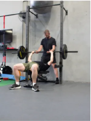 Two men weight training with bench press assist at Fortify Movement & Health