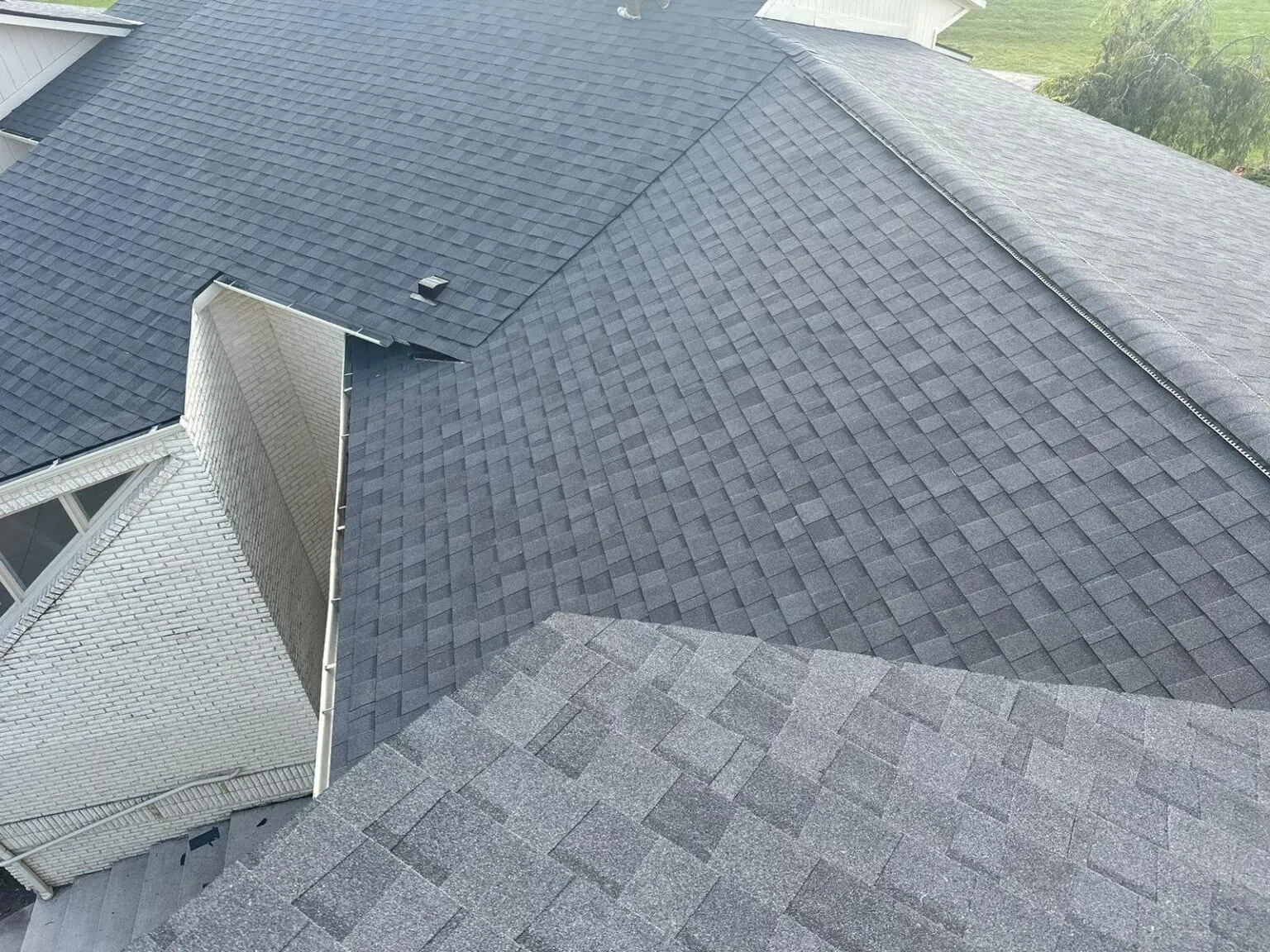 Comparison of light and dark roof colors on homes in Michigan demonstrating energy efficiency benefits