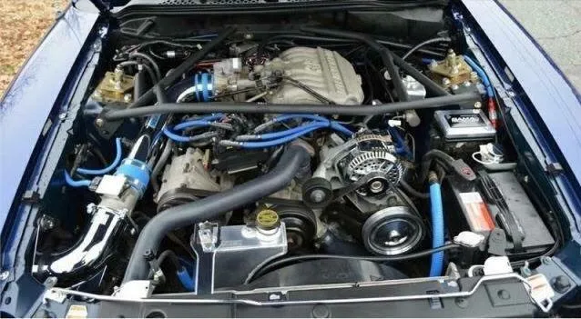Mechanic performing engine repairs, focused on high-cost services and efficient management strategies