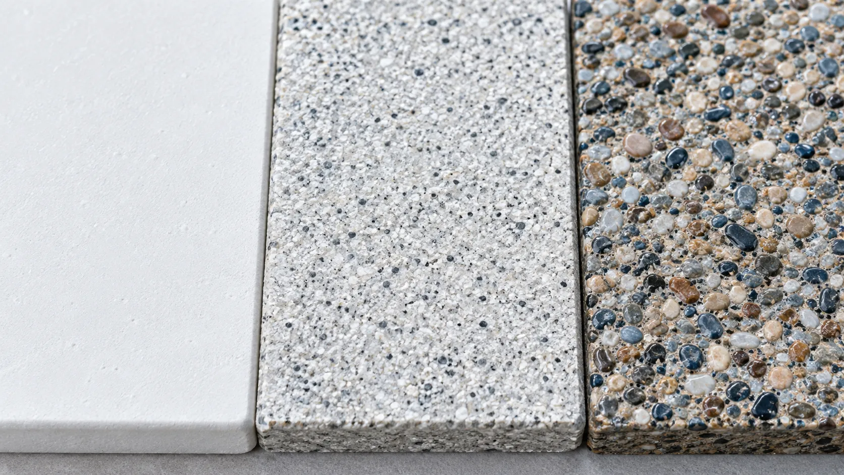 Close-up of pool plaster, quartz, and pebble interior finishes