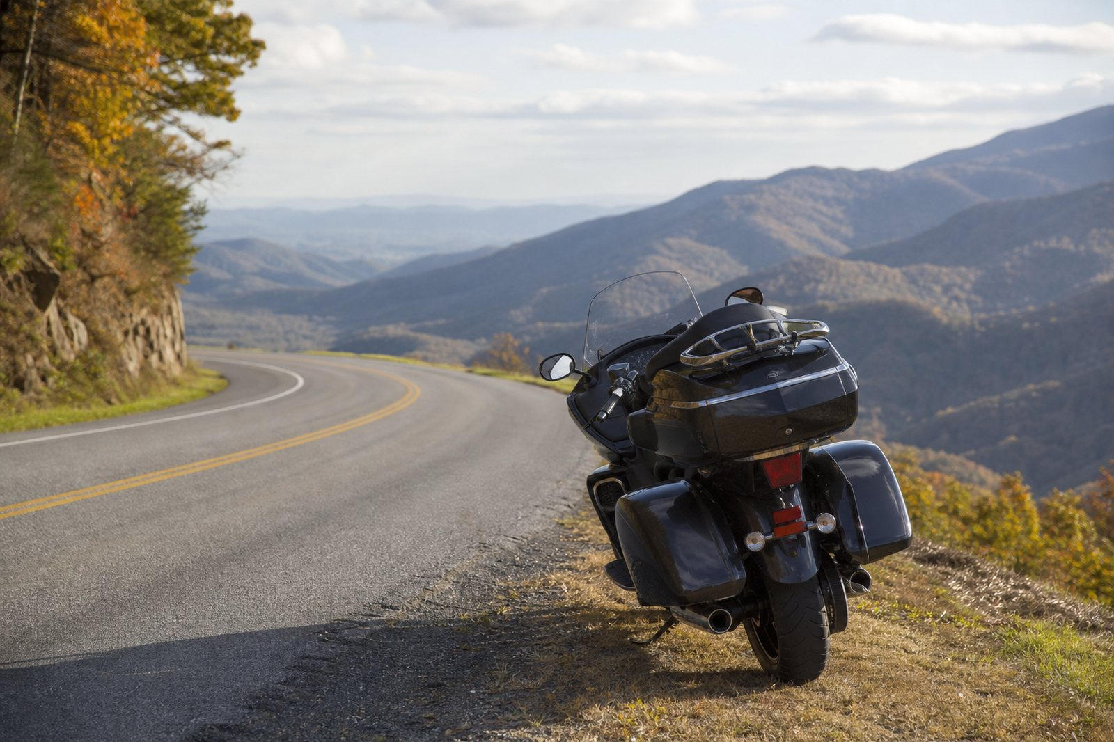 Touring motorcycle parked on a winding Blue Ridge mountain road in Virginia