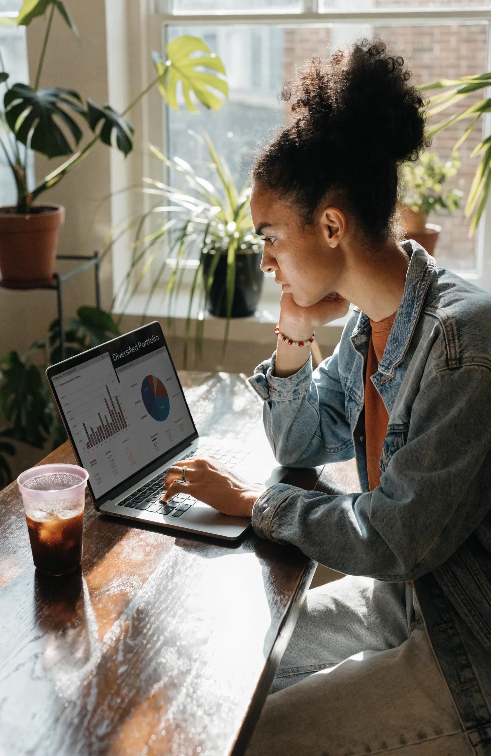 Individual analyzing alternative investment portfolio in a cozy home office setting