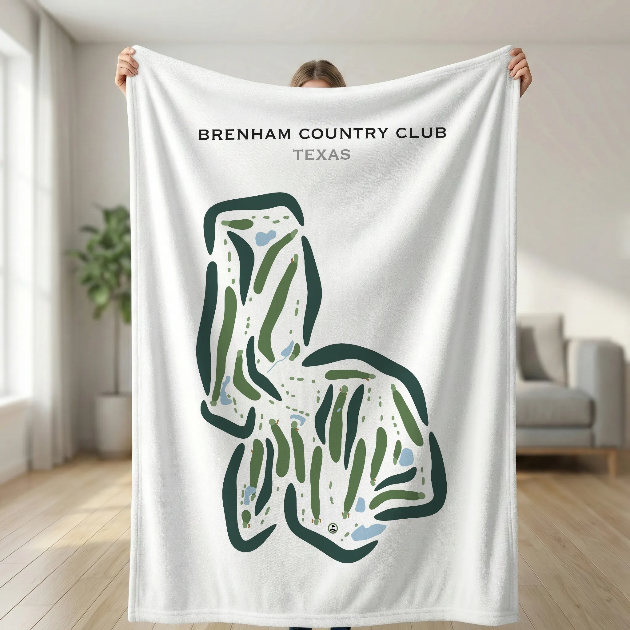 Person holding white blanket with Brenham Country Club Texas golf course map