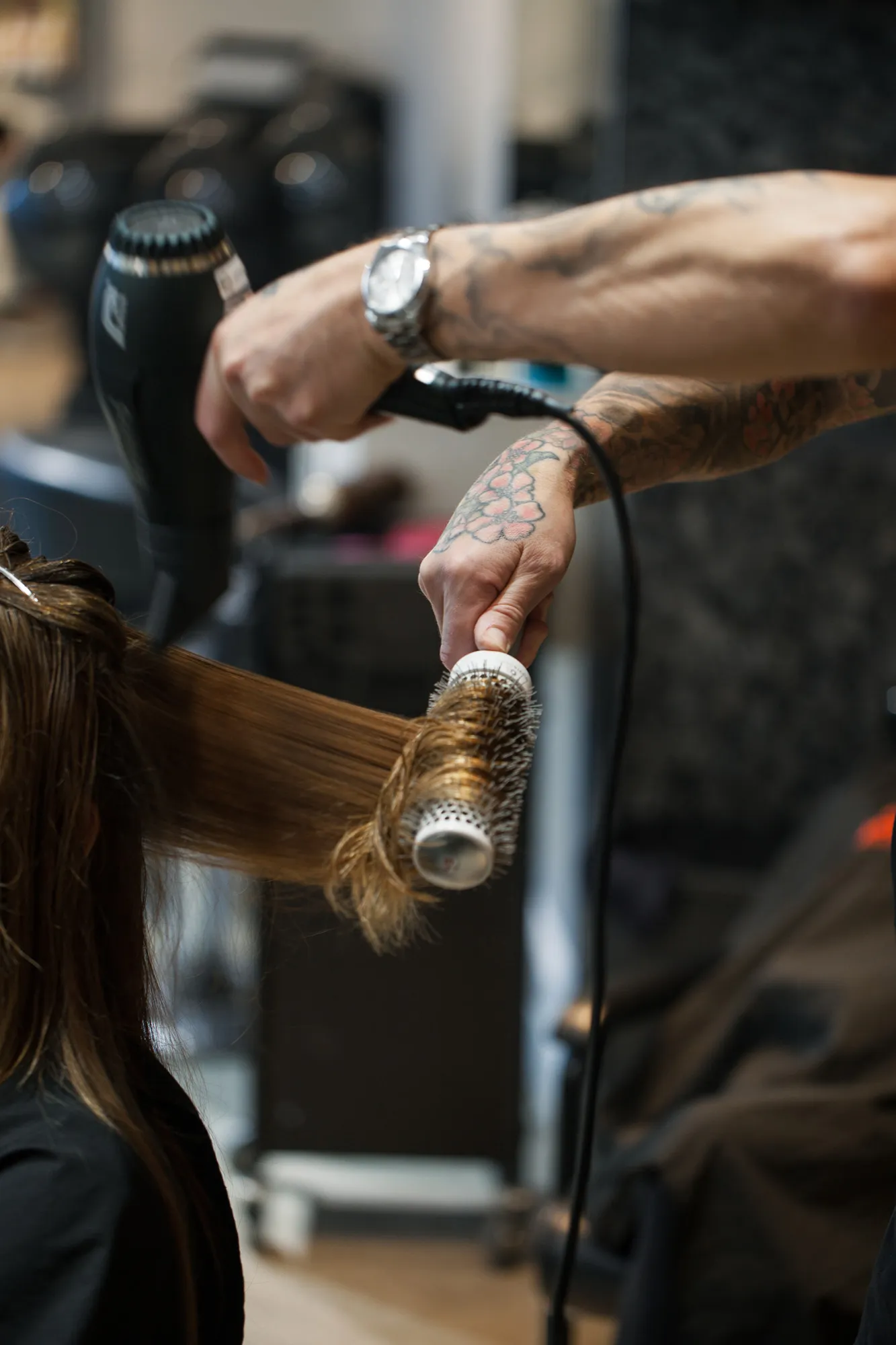 Stylist sealing a keratin treatment into the hair with a flat iron