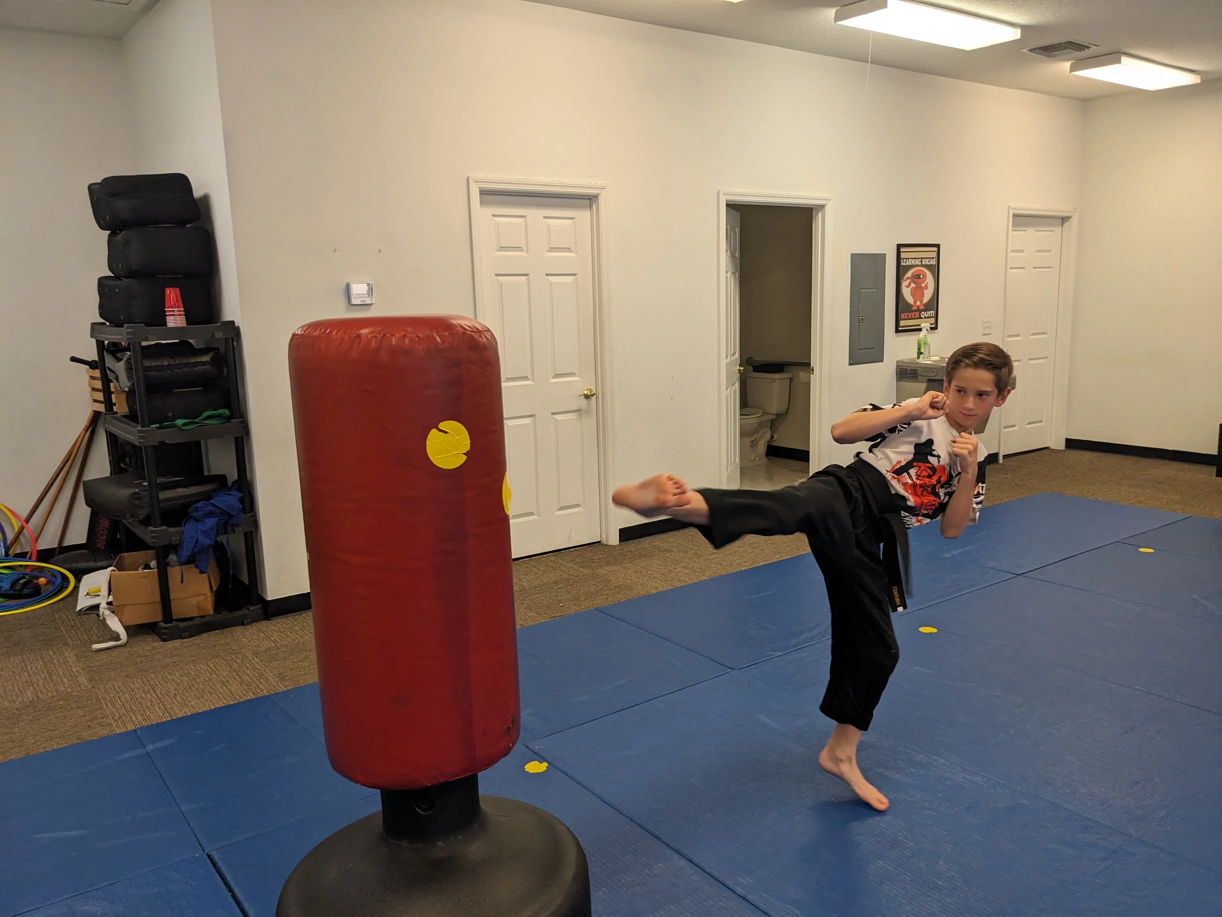 Teens and adults engaging in outdoor martial arts training, illustrating the numerous benefits of physical fitness and social skills.