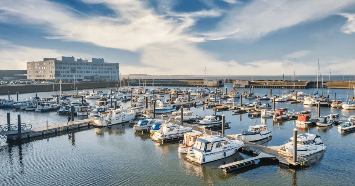 Handing over boat keys at a sunny marina — quick, simple sale